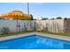 Swimming pool with an umbrella, lounge chairs, and backyard at 1702 W Glenrosa Ave, Phoenix, AZ 85015