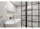 Spa-like bathroom boasts a modern freestanding tub and a glass-enclosed shower with marble tile at 1713 W Palomino Dr, Chandler, AZ 85224