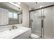 Modern bathroom with marble countertop, updated shower with sliding glass door, and a large vanity mirror at 1713 W Palomino Dr, Chandler, AZ 85224