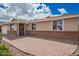 Charming home featuring a brick-accented facade and an inviting front entrance with decorative security door at 1713 W Palomino Dr, Chandler, AZ 85224
