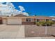 Charming single-story home featuring a two-car garage, desert landscaping, and a blue sky backdrop at 1713 W Palomino Dr, Chandler, AZ 85224
