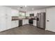 Bright kitchen features stainless steel appliances, white cabinets, and wood-look floors at 1713 W Palomino Dr, Chandler, AZ 85224