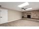 Inviting living room featuring a stone fireplace, ceiling fan, and wood-look flooring at 1713 W Palomino Dr, Chandler, AZ 85224
