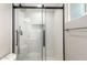 A shower featuring a frameless glass door, tile surround, built-in niche, and updated fixtures at 1713 W Palomino Dr, Chandler, AZ 85224