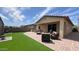 Lovely backyard showcasing pavers, artificial turf, a hot tub and outdoor seating area, perfect for entertaining at 17211 W Whispering Wind Rd, Surprise, AZ 85387