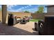 Cozy backyard patio with stylish wicker furniture, beautiful pavers and artificial turf at 17211 W Whispering Wind Rd, Surprise, AZ 85387