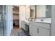 Bright bathroom with double vanity, modern fixtures, and a glass-enclosed shower at 17211 W Whispering Wind Rd, Surprise, AZ 85387