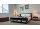 Cozy bedroom featuring a dark wood bed frame with a colorful quilt at 17211 W Whispering Wind Rd, Surprise, AZ 85387