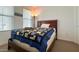 Bedroom featuring a queen size bed with wooden bed frame and window at 17211 W Whispering Wind Rd, Surprise, AZ 85387