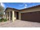 Charming single-story home boasts a brick driveway and a convenient attached two-car garage at 17211 W Whispering Wind Rd, Surprise, AZ 85387
