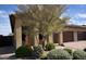 Lush front yard with mature landscaping and a decorative fountain adds to the home's charm at 17211 W Whispering Wind Rd, Surprise, AZ 85387