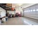 Spacious garage with epoxy flooring, overhead racks and ample storage space at 17211 W Whispering Wind Rd, Surprise, AZ 85387