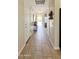 Bright hallway featuring neutral tile flooring and access to other rooms, providing a welcoming entrance at 17211 W Whispering Wind Rd, Surprise, AZ 85387