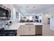 Bright kitchen with stainless steel appliances and open floor plan to living area at 17211 W Whispering Wind Rd, Surprise, AZ 85387