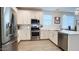 Modern kitchen with stainless steel appliances, white cabinets, subway tile backsplash and tile flooring at 17211 W Whispering Wind Rd, Surprise, AZ 85387