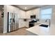 Modern kitchen featuring stainless steel appliances, white cabinets, subway tile backsplash, and tiled flooring at 17211 W Whispering Wind Rd, Surprise, AZ 85387