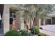Lush landscaping featuring a decorative fountain and mature trees enhances the home's curb appeal at 17211 W Whispering Wind Rd, Surprise, AZ 85387