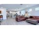 Open-concept living area with tile floors and a view of the modern kitchen and dining space at 17211 W Whispering Wind Rd, Surprise, AZ 85387