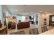 Open-concept living room with tile floors, neutral paint, leather sofas, and sliding doors to backyard patio at 17211 W Whispering Wind Rd, Surprise, AZ 85387