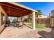 Relaxing backyard offers a covered patio with outdoor furniture, artificial grass, and desert landscaping at 1737 E Primera Dr, Casa Grande, AZ 85122
