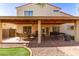 Entertain in this backyard featuring a covered patio, outdoor seating, grilling area, and desert landscaping at 1737 E Primera Dr, Casa Grande, AZ 85122