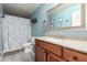 Bathroom with wood cabinets, granite counters, and a shower/tub combo at 1737 E Primera Dr, Casa Grande, AZ 85122