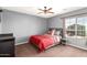 Bedroom features a ceiling fan, gray walls, and a bright window at 1737 E Primera Dr, Casa Grande, AZ 85122
