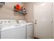 Laundry room with white appliances and overhead storage at 1737 E Primera Dr, Casa Grande, AZ 85122