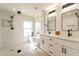 Modern bathroom featuring a glass shower, soaking tub, dual vanity sinks, and stylish fixtures at 1747 W Echo Ln, Phoenix, AZ 85021