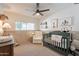 Cozy Bedroom with wainscoting, a crib, rocking chair, and charming decor at 1747 W Echo Ln, Phoenix, AZ 85021