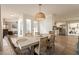 Elegant dining area with a stylish table, rattan chairs, and modern light fixture at 1747 W Echo Ln, Phoenix, AZ 85021