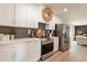 Stylish kitchen with stainless steel appliances, white cabinetry, and modern countertops at 1747 W Echo Ln, Phoenix, AZ 85021