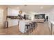 Bright kitchen with island and breakfast bar featuring white cabinetry and modern appliances at 1747 W Echo Ln, Phoenix, AZ 85021