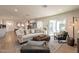 Comfortable living room with stylish sofa, ottoman, and access to the kitchen and patio at 1747 W Echo Ln, Phoenix, AZ 85021