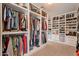 Bright walk-in closet features extensive shelving, hanging racks, and designated shoe storage space at 1747 W Echo Ln, Phoenix, AZ 85021