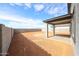 Spacious backyard with a covered patio, concrete pillars and block wall fencing at 17977 W Camino De Oro Riv, Surprise, AZ 85387