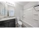 Well-lit bathroom with modern fixtures, a granite countertop vanity, and a shower-tub combo at 17977 W Camino De Oro Riv, Surprise, AZ 85387