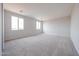 Spacious bedroom featuring neutral carpeting, recessed lighting, and bright windows with scenic views at 17977 W Camino De Oro Riv, Surprise, AZ 85387