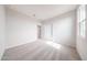 Bright bedroom with neutral carpet, white walls, closet, and an open door to the hallway at 17977 W Camino De Oro Riv, Surprise, AZ 85387