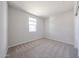 Bright bedroom with neutral carpet flooring and a window that provides plenty of natural light at 17977 W Camino De Oro Riv, Surprise, AZ 85387