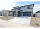 Beautiful two-story home with modern design, desert landscape, and inviting entrance at 17977 W Camino De Oro Riv, Surprise, AZ 85387