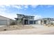Beautiful gray two-story home featuring desert landscaping and a spacious driveway at 17977 W Camino De Oro Riv, Surprise, AZ 85387