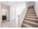 Bright foyer with stairway, neutral tile flooring, and access to a downstairs powder room at 17977 W Camino De Oro Riv, Surprise, AZ 85387