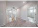 Second floor hallway showcasing neutral carpeting, recessed lighting, and a view of the staircase at 17977 W Camino De Oro Riv, Surprise, AZ 85387