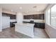 Modern kitchen featuring granite countertops, sleek cabinets, and stainless steel appliances at 17977 W Camino De Oro Riv, Surprise, AZ 85387