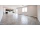 Large open living room with tile flooring and kitchen view at 17977 W Camino De Oro Riv, Surprise, AZ 85387