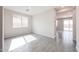 A bright living room is highlighted by neutral tile flooring and plenty of natural light at 17977 W Camino De Oro Riv, Surprise, AZ 85387