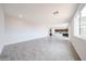 Open-concept living area with kitchen view, tile flooring, and recessed lighting at 17977 W Camino De Oro Riv, Surprise, AZ 85387