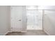 Close-up of glass enclosed shower featuring tiled floors and a built-in seat at 17977 W Camino De Oro Riv, Surprise, AZ 85387