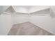 Walk-in closet featuring neutral carpeting and wooden hanging rods at 17977 W Camino De Oro Riv, Surprise, AZ 85387